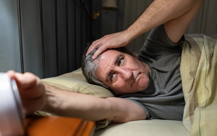 Sleepless man looking at clock